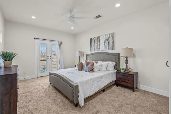 a bedroom with a bed and a potted plant