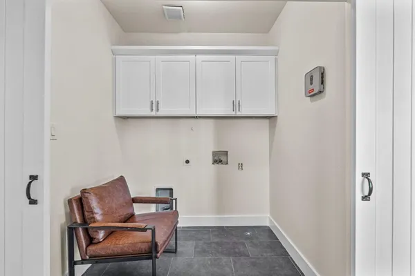 a room with workbench and wooden cabinets