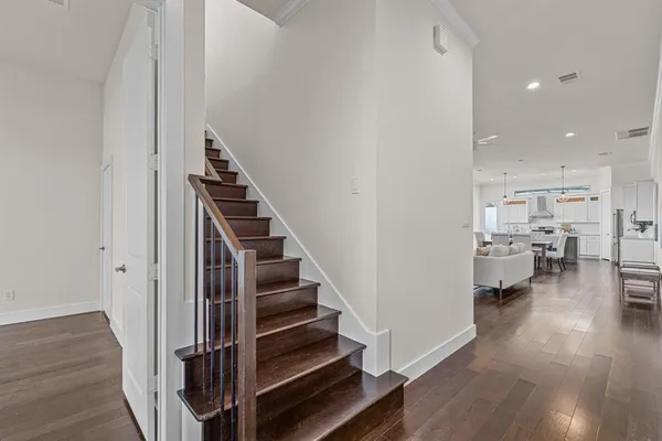 a view of entryway and hall with wooden floor