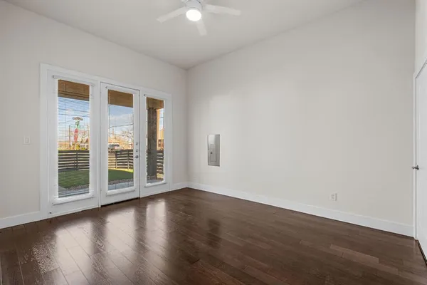 a view of a livingroom with wooden floor and a window