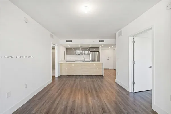 a view of a kitchen with wooden floor