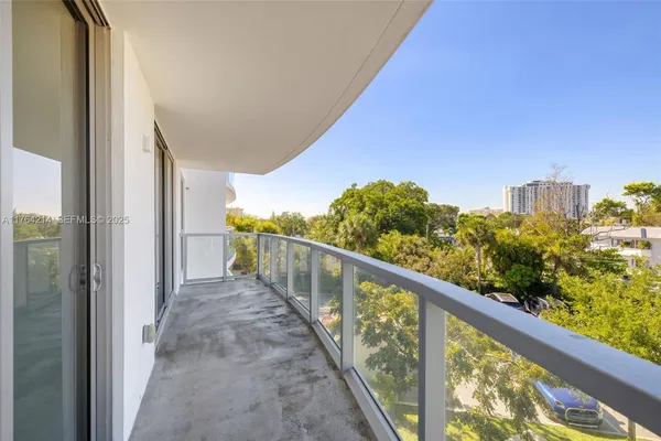 a view of a balcony with wooden floor