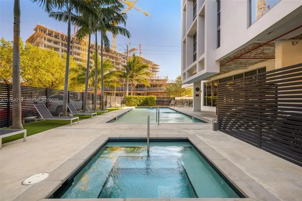 a swimming pool with chairs