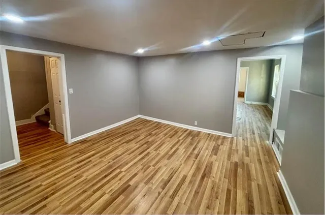 a view of a room with wooden floor