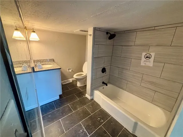 a bathroom with a toilet and shower