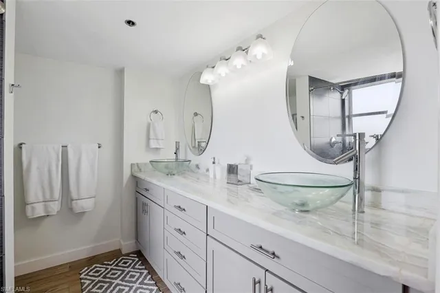 a bathroom with a double vanity sink and a mirror