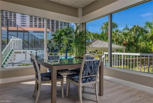 a patio with yard glass top table and chairs