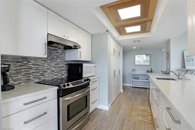 a kitchen with a sink appliances and cabinets