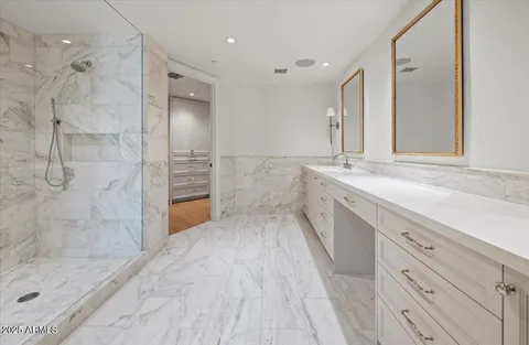a bathroom with a granite countertop sink mirror and shower