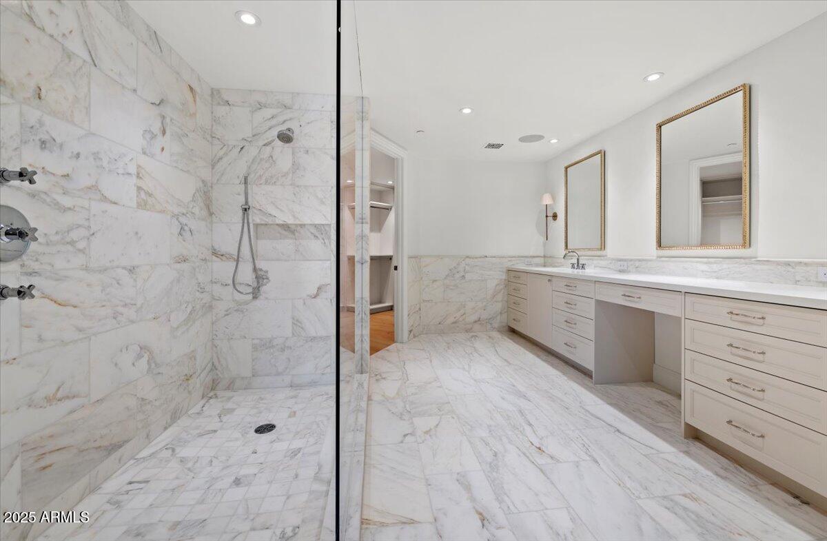 7181 East Camelback Road, Unit 301 Scottsdale, AZ 85251 - Photo 12 of 22 a bathroom with a granite countertop sink mirror and shower
