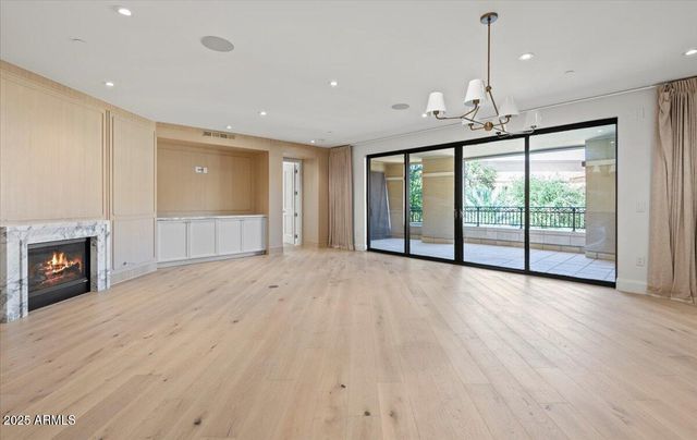 a view of an empty room with a fireplace and a window
