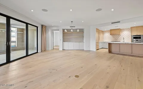 a large kitchen with stainless steel appliances kitchen island granite countertop a large counter top and a stove