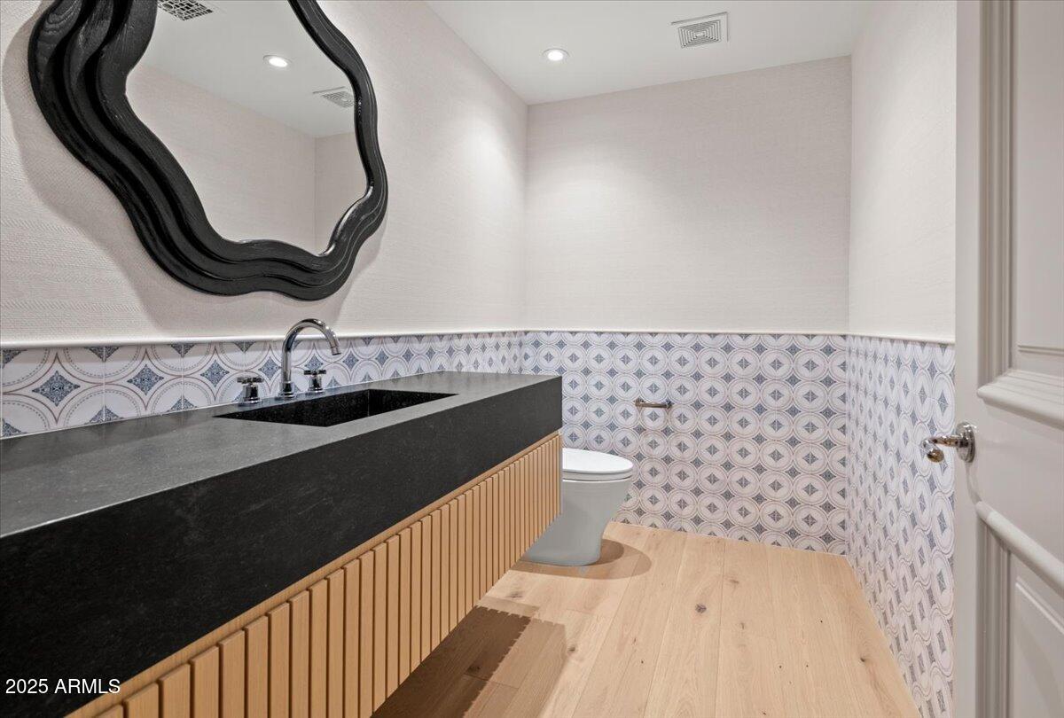 7181 East Camelback Road, Unit 301 Scottsdale, AZ 85251 - Photo 8 of 22 a bathroom with a sink a toilet and a mirror