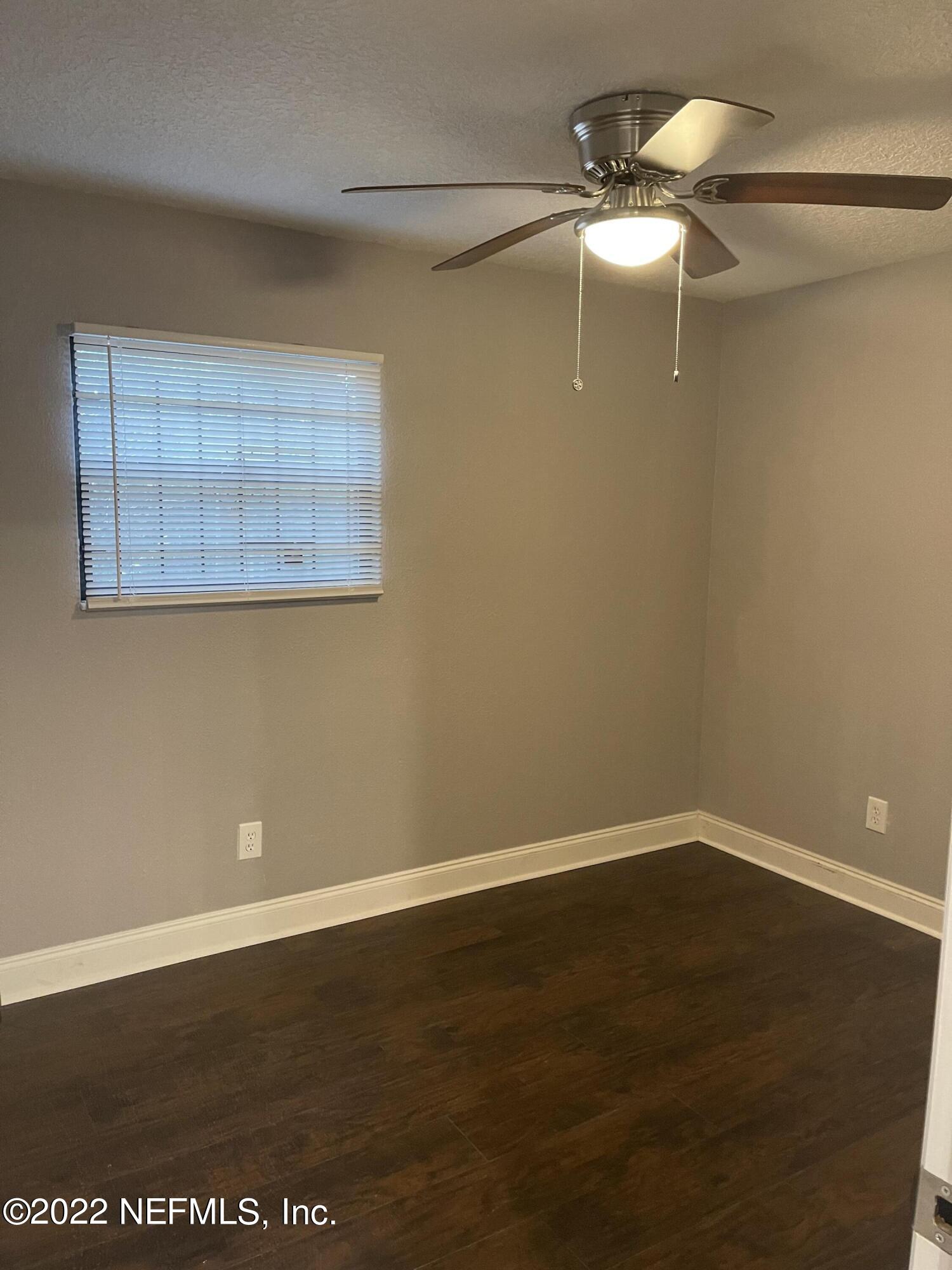 3111 Ray Road Jacksonville, FL 32209 - Photo 11 of 19 en empty room with wooden floor and fan