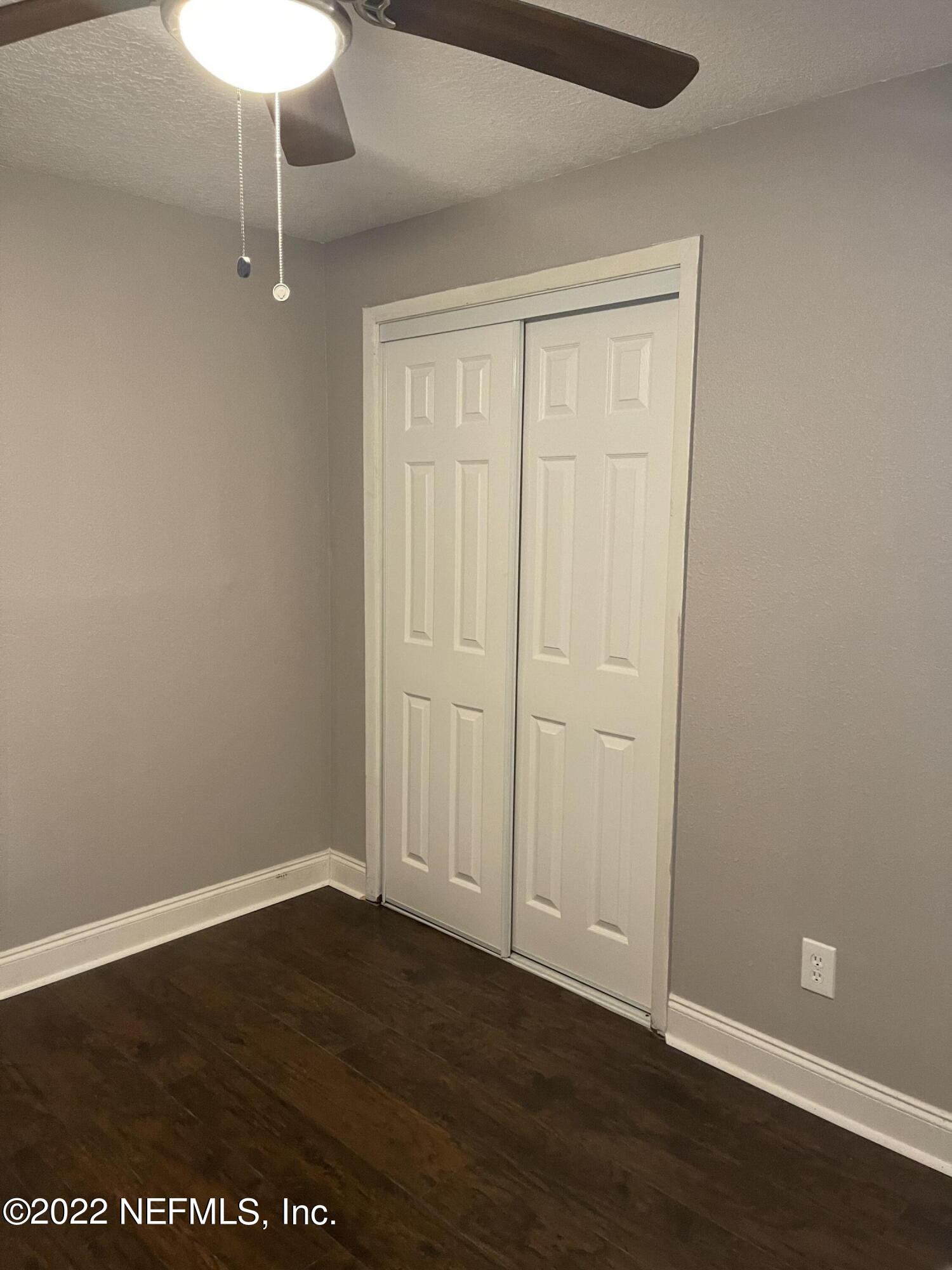 3111 Ray Road Jacksonville, FL 32209 - Photo 14 of 19 a view of an empty room with wooden floor and a window