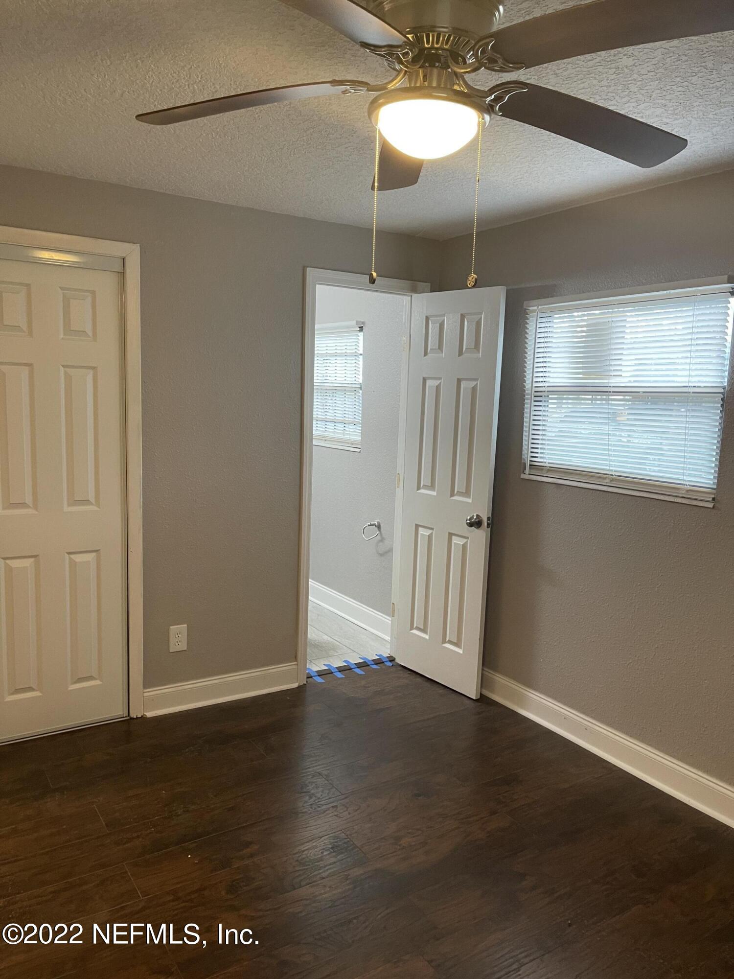 3111 Ray Road Jacksonville, FL 32209 - Photo 16 of 19 an empty room with wooden floor and windows