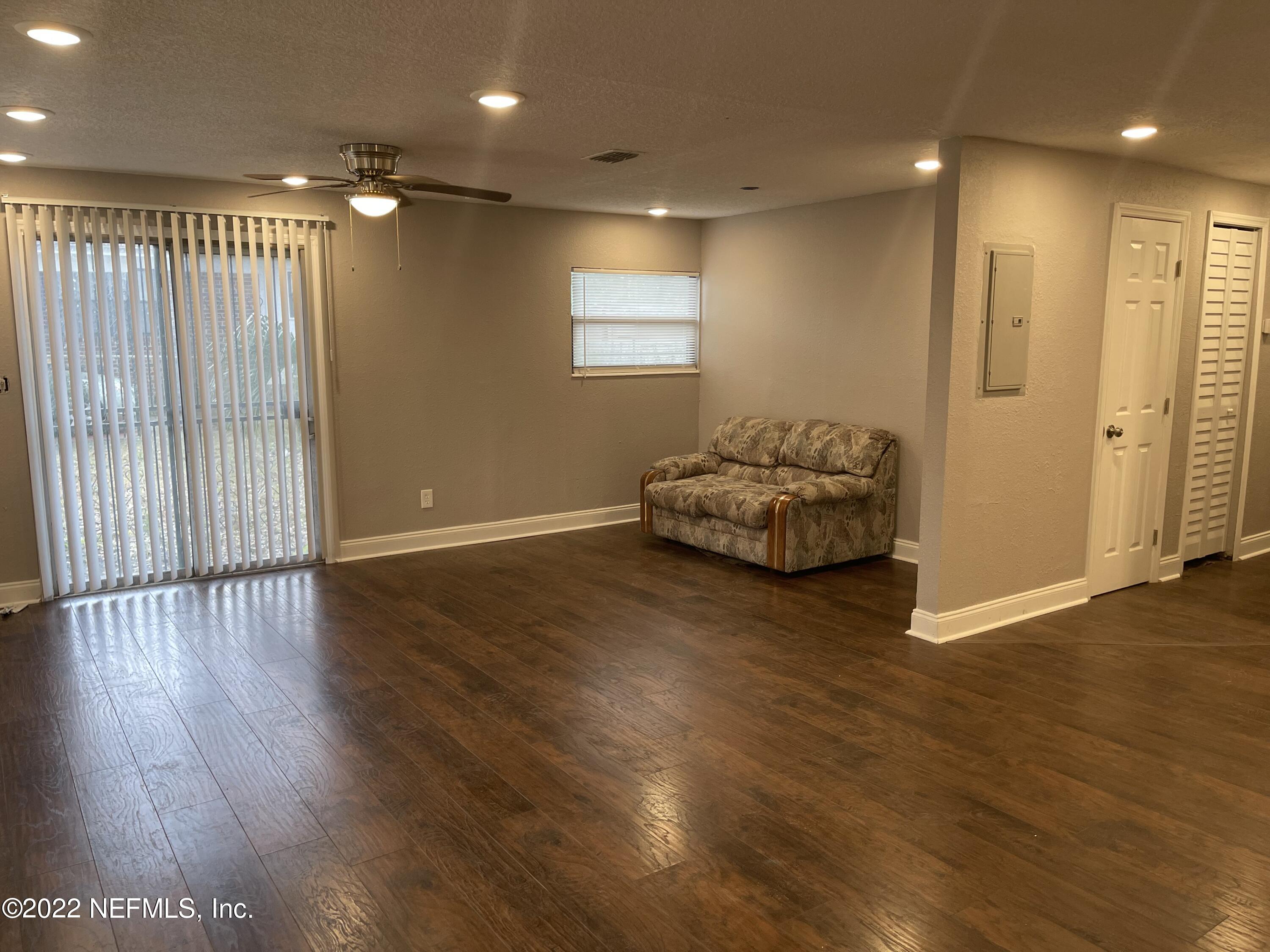 3111 Ray Road Jacksonville, FL 32209 - Photo 4 of 19 an empty room with wooden floor and windows