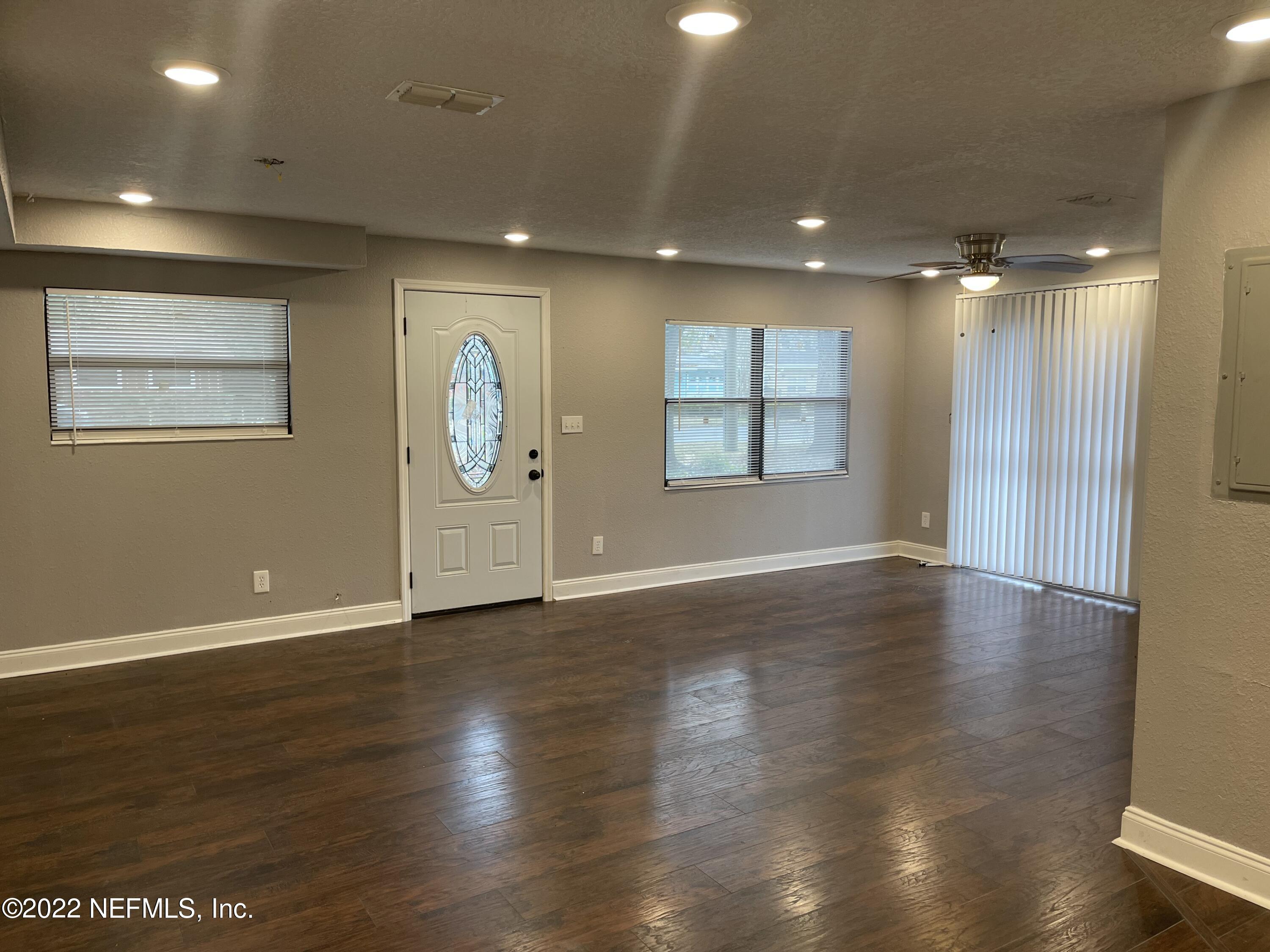 3111 Ray Road Jacksonville, FL 32209 - Photo 5 of 19 an empty room with wooden floor and windows