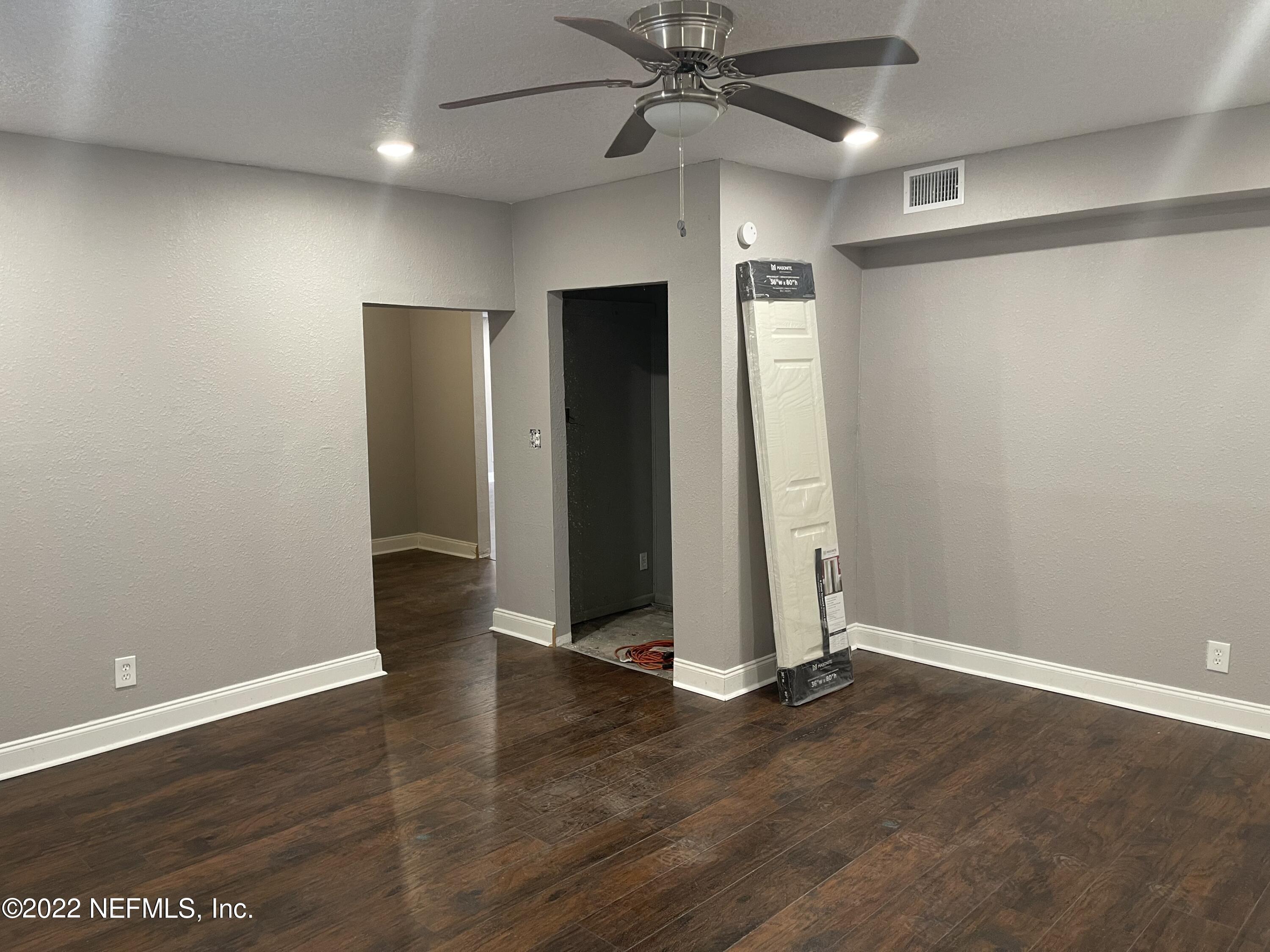 3111 Ray Road Jacksonville, FL 32209 - Photo 8 of 19 an empty room with wooden floor closet and windows