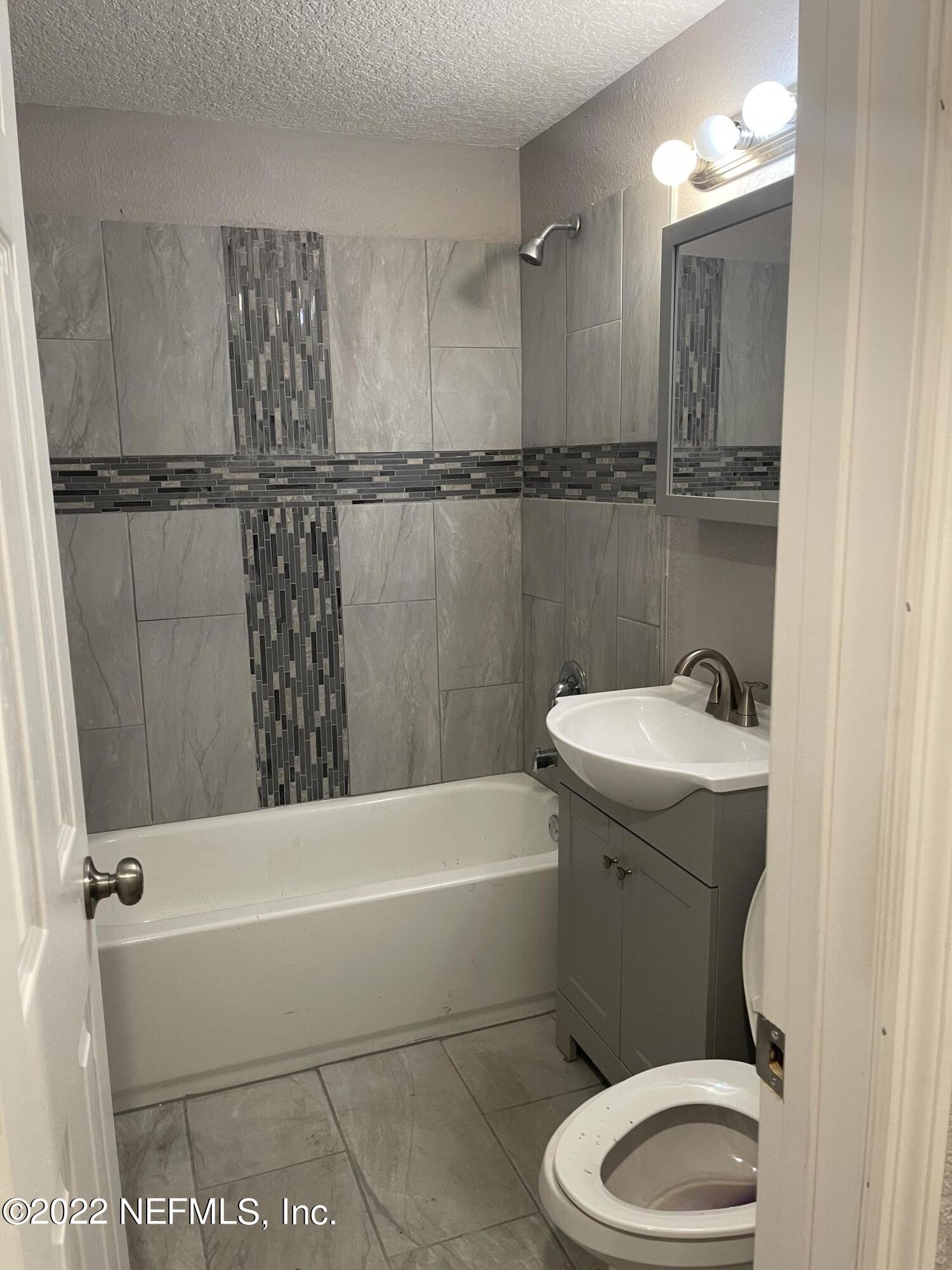 3111 Ray Road Jacksonville, FL 32209 - Photo 10 of 19 a bathroom with a sink a toilet and shower