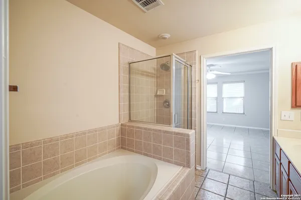 a bathroom with a tub and shower