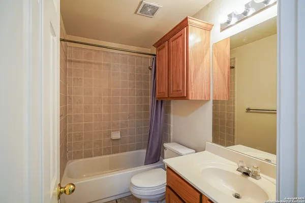 a bathroom with a sink mirror toilet and bathtub
