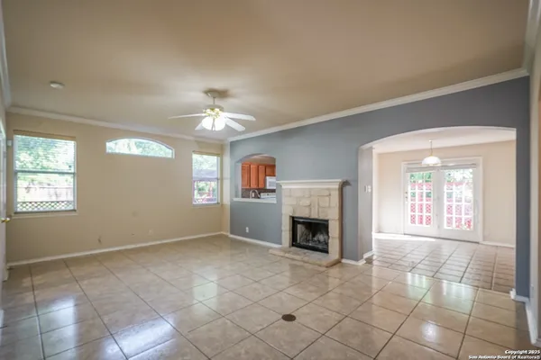 a view of an empty room with a fireplace and a window