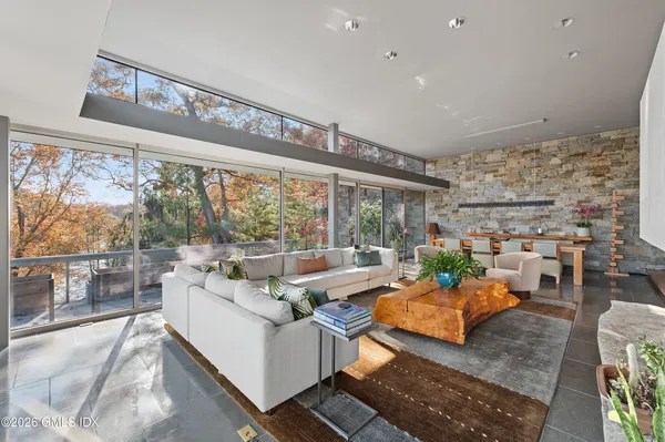 a living room with patio furniture and a large window