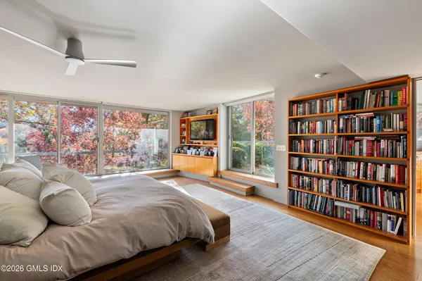 a bedroom with a bed and a book shelf