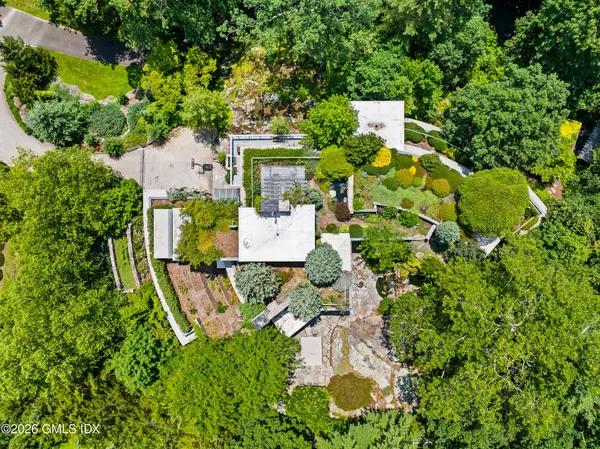 an aerial view of a house with a yard and garden