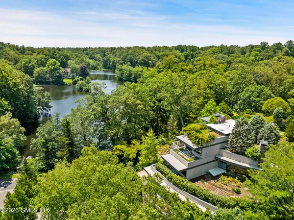 a view of a lake with houses in back