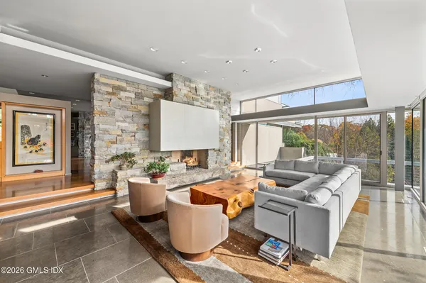 a living room with patio furniture and a large window