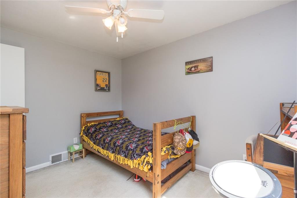 386 Hodgson Road Darlington, PA 16115 - Photo 14 of 21 Bedroom 3 offers ceiling fan, neutral tones, wall-wall carpeting!