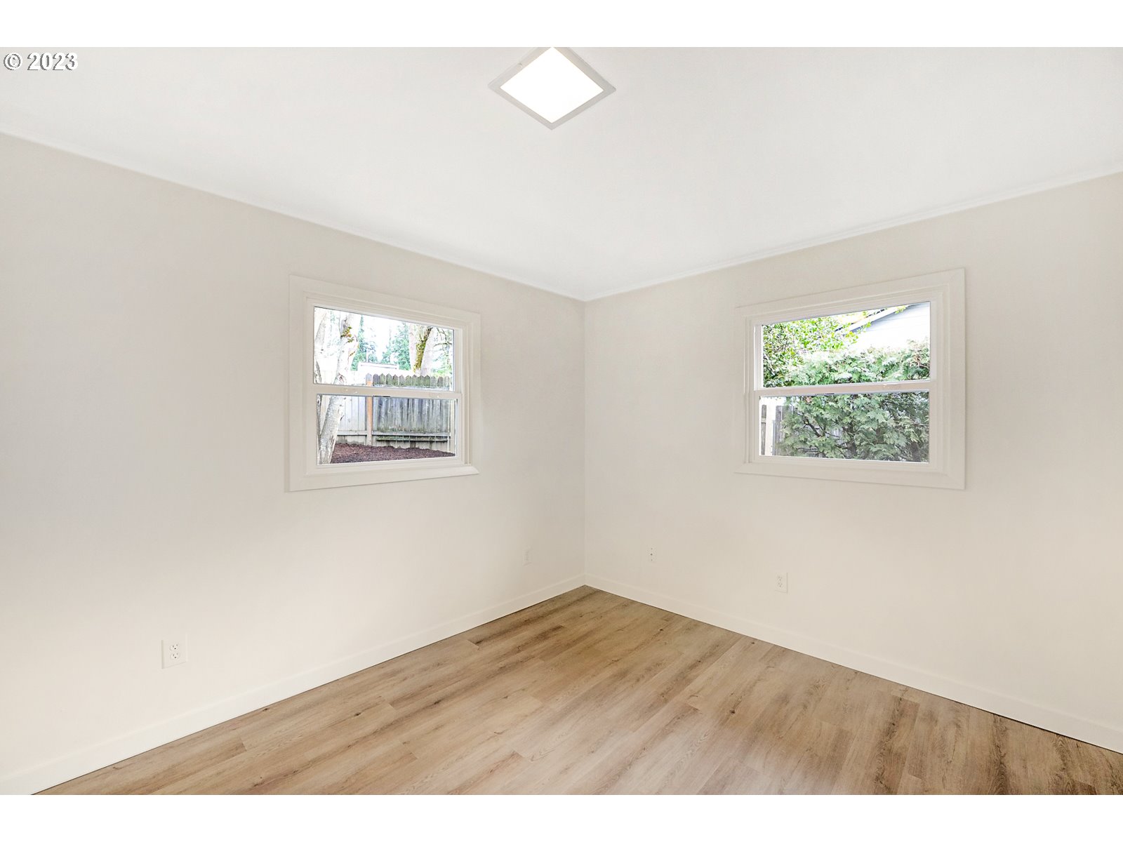 8900 Southwest 69th Avenue Portland, OR 97223 - Photo 22 of 31 an empty room with wooden floor and windows