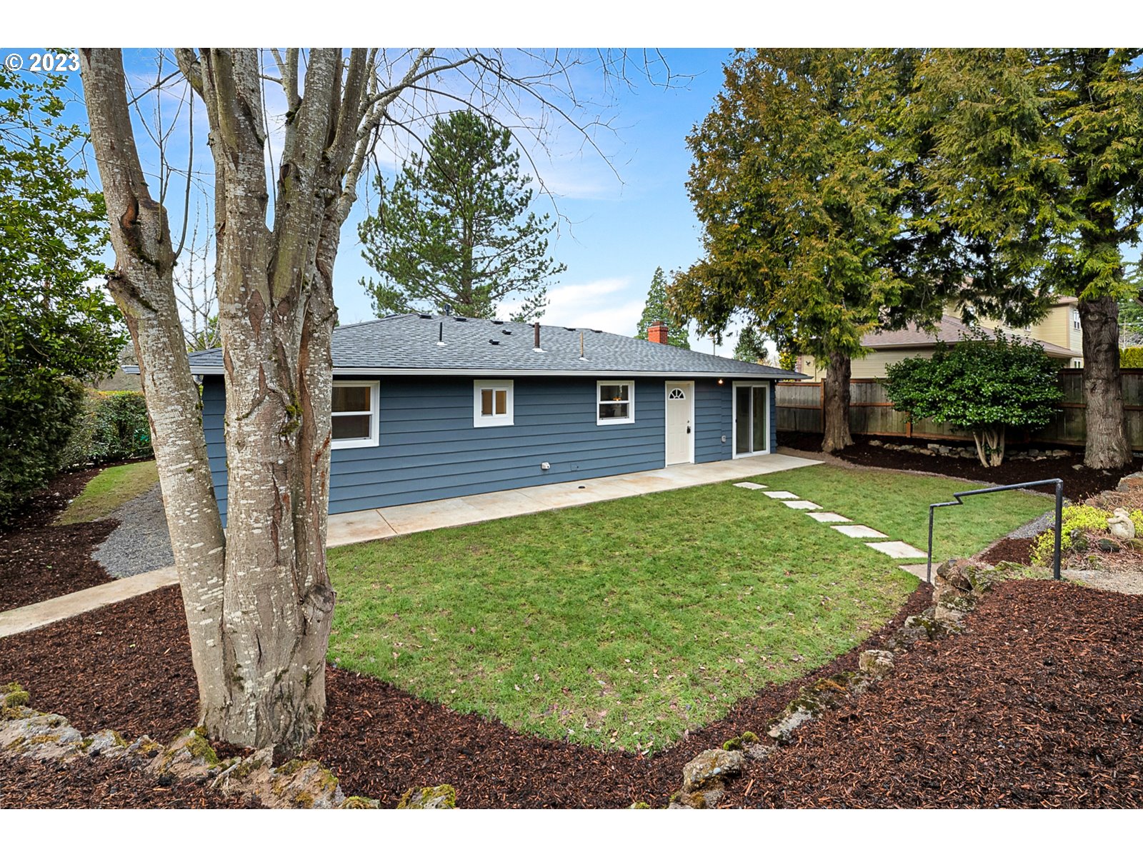 8900 Southwest 69th Avenue Portland, OR 97223 - Photo 27 of 31 a view of a house with backyard and a tree