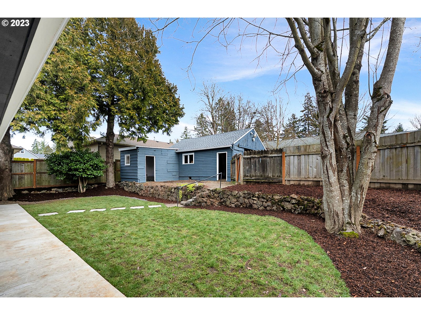 8900 Southwest 69th Avenue Portland, OR 97223 - Photo 28 of 31 a front view of a house with a garden