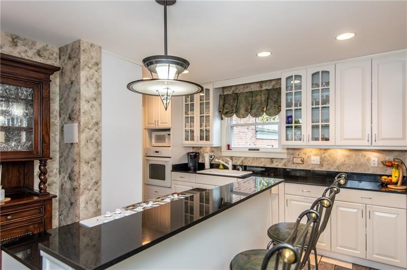1265 Highland Road Sharon, PA 16146 - Photo 8 of 25 Pretty white kitchen with breakfast bar and appliance package.