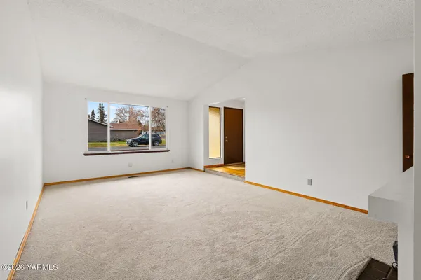 an empty room with fireplace