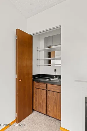 a view of a livingroom with a kitchen