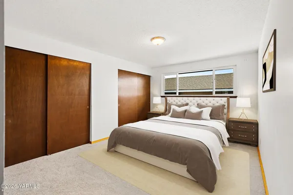 a bedroom with a large bed and a window