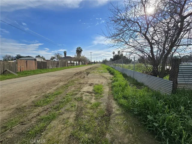 a view of a big yard with wooden fence