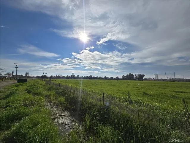 a view of a big yard with lots of green space and houses