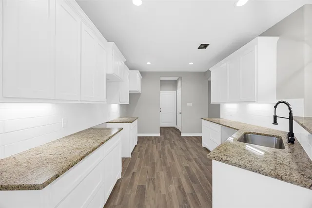 a kitchen with a sink and refrigerator