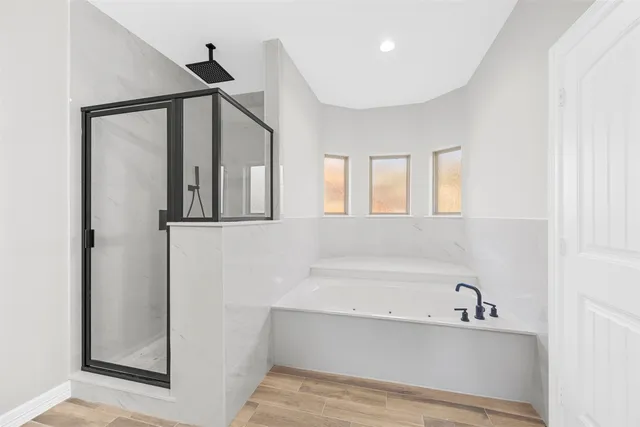 a bathroom with a bathtub and a shower