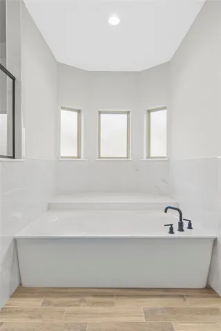 a bathroom with a bathtub and window