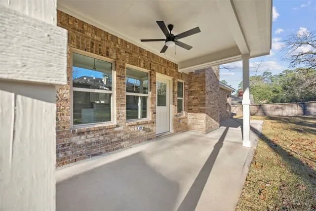 a view of a porch with a table and chairs