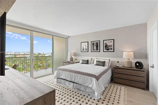 a bedroom with a bed and a large window with outer view