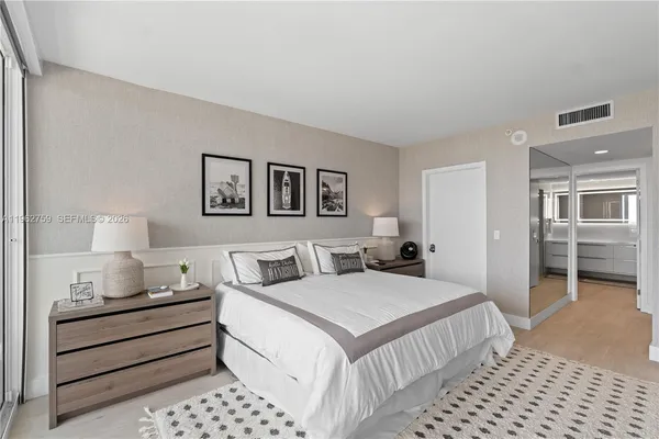 a bedroom with double bed and a lamp