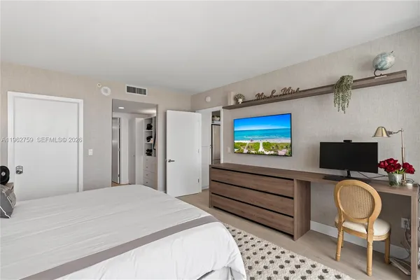 a bedroom with a bed and a chair