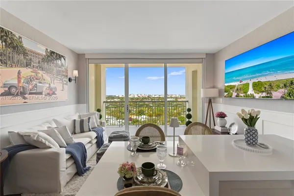 a living room with furniture a flat screen tv and a floor to ceiling window